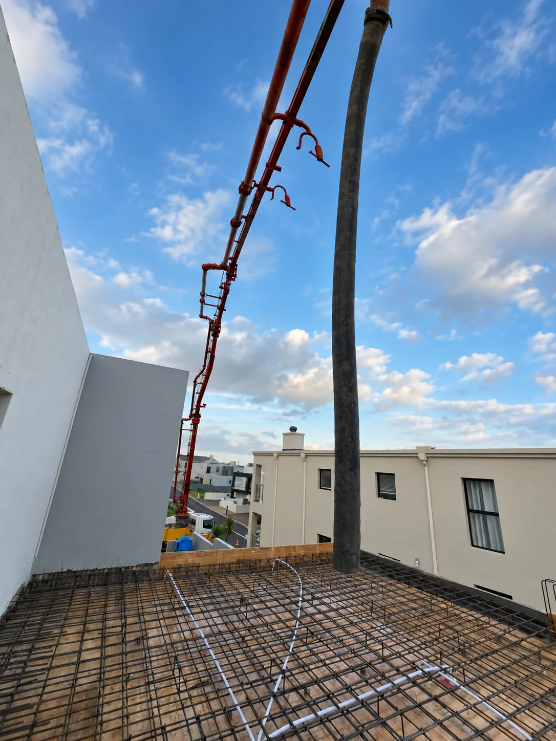 Concrete pump boom operating at a construction site